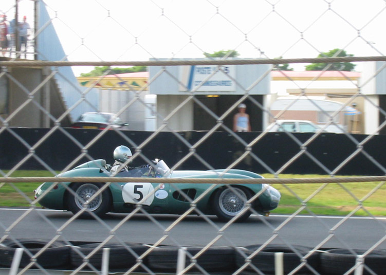 Nice green car, with blurry lady in the background, (I would!).